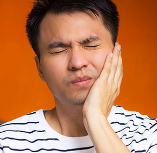 man suffering from jaw pain