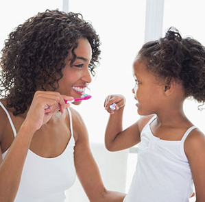 mother and child brushing their teeth